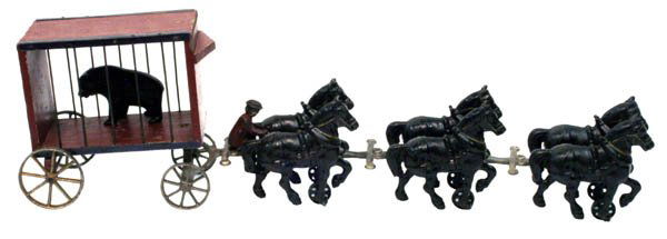 Arcade Circus Wagon With Bear.: 1926 C.I. with nickel plated wheels and wood circus cart. Size: 28" long. Cond.: Minor paint loss throughout yet retains teddy bear. Good to very good.