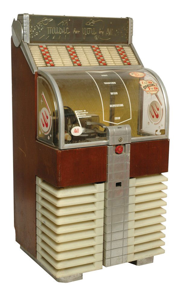 AMI Jukebox.: Art deco styled jukebox with curved front glass door operating on 45 rpm records. Size: 30" x 60". Cond.: Good original overall.