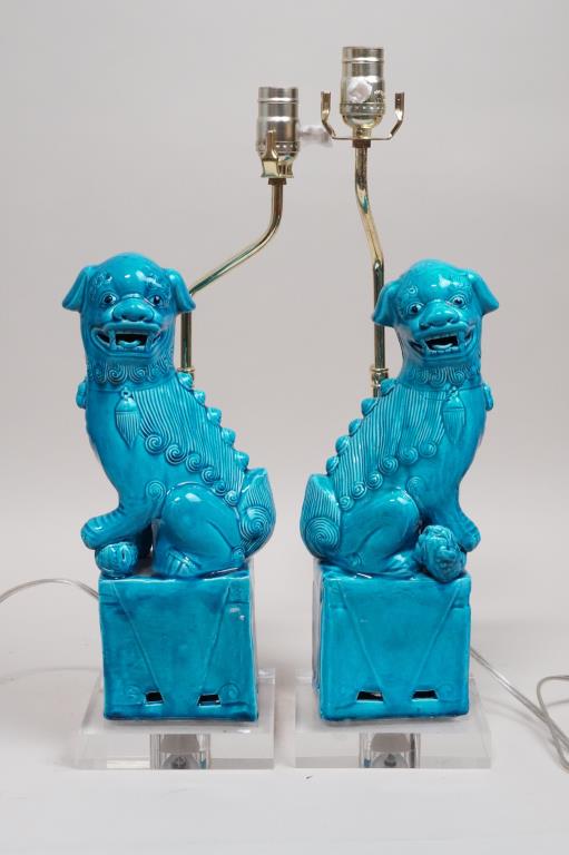 PAIR OF CHINESE PORCELAIN FIGURES OF FOO LION: Mounted as lamps, in beautiful bright turquoise color. Each sitting on a plinth with an open mouth. H: 14 1/2 in.