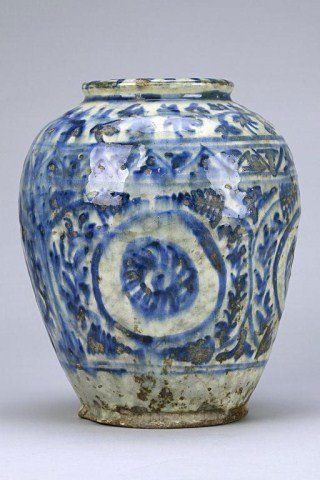 ANTIQUE TURKISH BLUE AND WHITE JAR: Of ovoid form, enameled to the body in cobalt blue tone with foliate design below gnarled tendrils and vines around the shoulder. H: 9 1/2 in.(24cm)