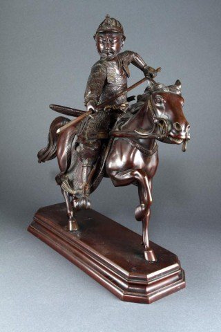 EXQUISITE JAPANESE BRONZE, OF A WARRIOR ON A HORSE: Extremely well casted bronze, wearing a full armor gear and weapons while holding a spear in striking stance, balancing himself with foot on stirrup while aboard a horse in motion. Total H: 16 1/8 in.