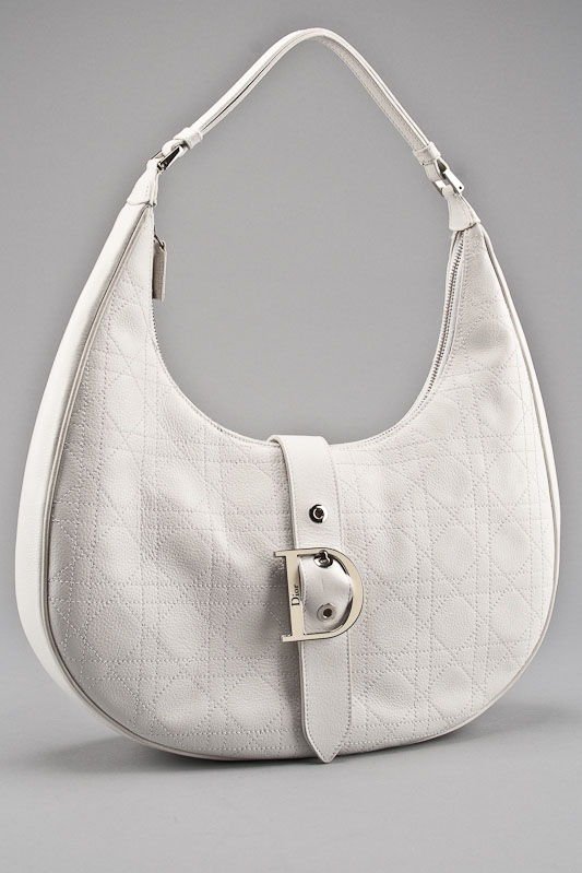 Christian Dior White Leather Cannage Hobo Bag: Designer: Christian Dior Material: Leather Color: White Style: Hobo Bag, Shoulder Bag, Everyday Bag Closure: Zipper and flap with magnetic closure Handle / Strap: Leather Hardware: Silver tone hardwar