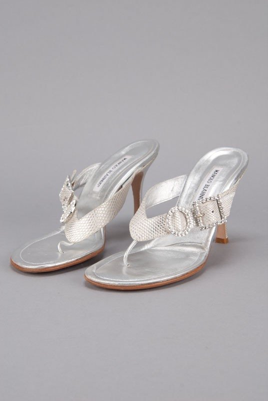 New Manolo Blahnik Silver Crystal Buckle Thong Heels: Designer: Manolo Blahnik Color: Silver Out-sole: Leather sole with slip resistant toe Lizard print leather body Double crystal buckle accent Thong style Lizard print self-covered heels <b