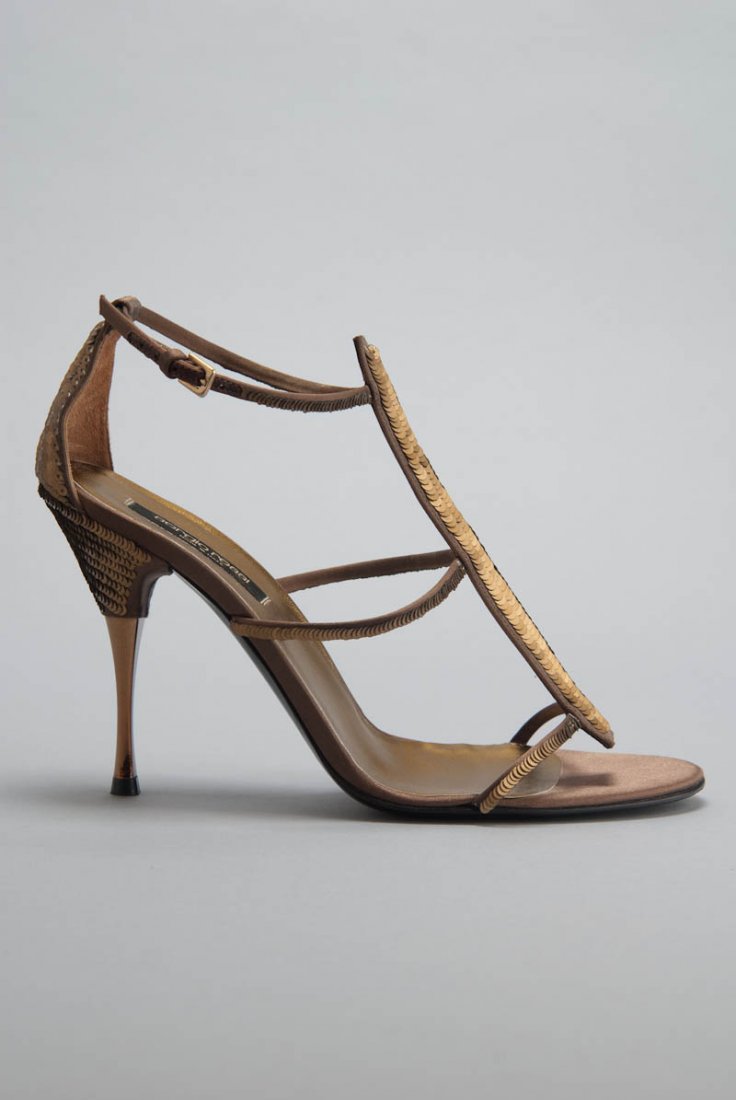 Sergio Rossi Bronze Sequin Sandals (9/39): Designer: Sergio Rossi Color: Bronze Strap / Closure: Buckle ankle strap, T-strap Out-sole: Leather sole Satin body Sequin covered body Open toe Stiletto heels Insole: 10.25" /