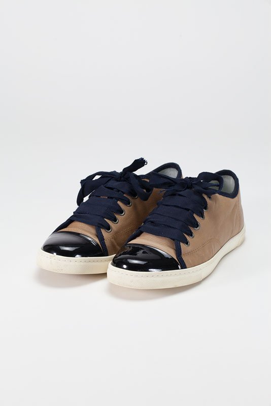 Lanvin Brown & Navy Tennis Shoes (9/39): Designer: Lanvin Color: Brown, Navy Blue Strap / Closure: Ribbon tie front Out-sole: Ribbed rubber sole Leather body Patent leather cap toe Metallic trim Ribbon trim