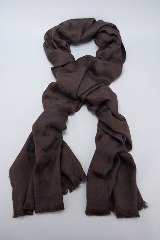 Escada Brown Signature Logo Fringe Trim Scarf: Designer: Escada Material: 100% Wool Color: Brown Signature logo body Fringe trim Tonal trim Original care tag Length: 56" Width: 29" Condition: Pre-owned Fabric / Material: Like New -