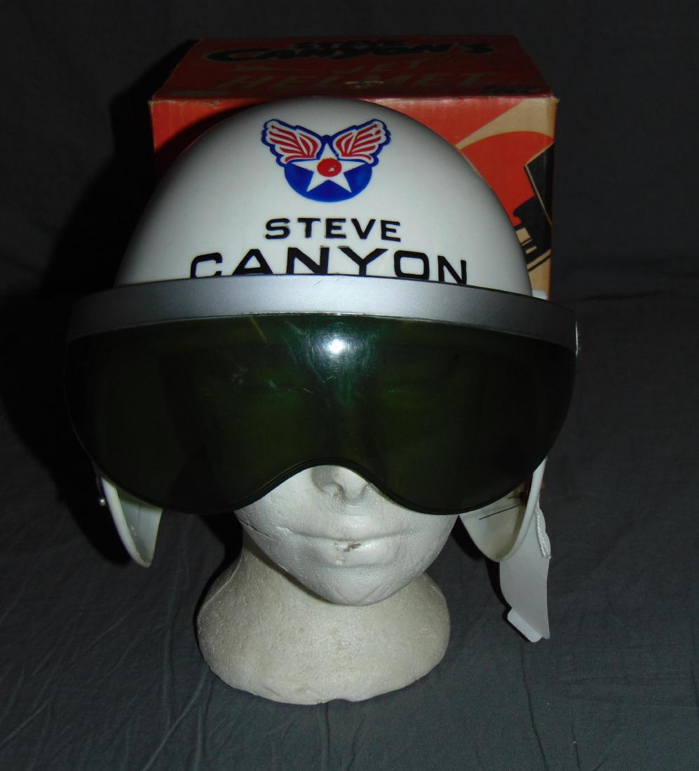 Boxed Ideal Steve Canyon Jet Helmet: Vintage Steve Canyon Jet Helmet in Original Box by Ideal. Helmet features original visor. Missing speaker mask with elastic straps. Some scuffs and scratches to visor and helmet. Box is in very good c