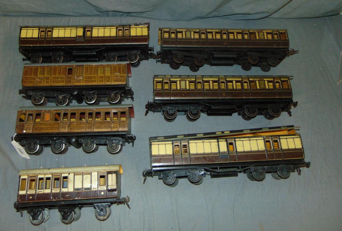7 Carette Gauge 1 English Outline Cars: Includes assorted length compartment coaches and guard cars, all litho tin. Some are missing buffers and a few couplers. grade range is Good to very good.