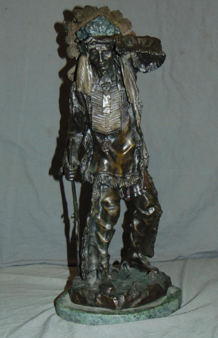 After Carl Kauba, Chief White Clound Indian Bronze: Lot consists of a bronze sculpture after Carl Kauba, titled "Chief White Cloud" depicting an Indian holding a rifle in one hand and blocking the sun with the other. Approx. 20" tall. Signed C. Kauba. 