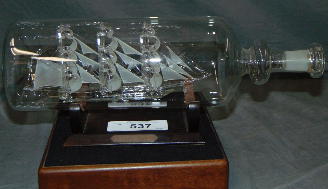 Glass Cutty Sark in a Bottle.: Beautiful piece with a stand.