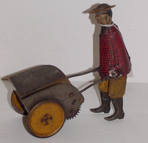 LEHMANN. WIND UP TOY.: MAN AND PUSHCART. WORKING ORDER. NEEDS A GOOD CLEANING.