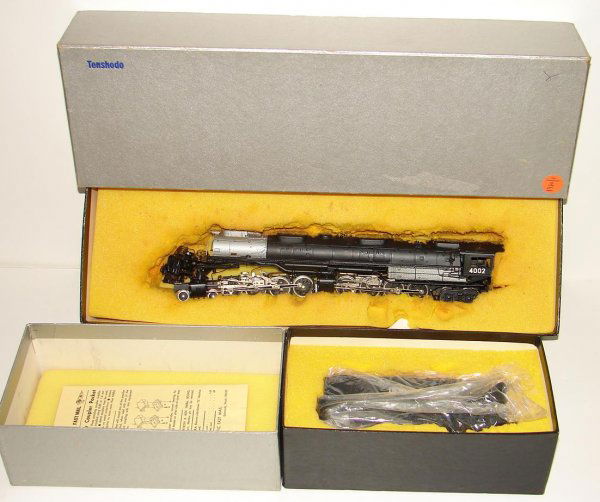 BRASS TENSHODO UP 4-8-8-4 BIG BOY & TENDER: BOXED HO BRASS ENGINE & TENDER, UNION PACIFIC 4-8-8-4 "BIG BOY", TENSHODO, NO.126. BLACK FACTORY PAINT. ROAD NUMBER 4002. ENGINE HAS FOAM STUCK TO THE TOP FROM BEING STORED AWAY OVER THE YEARS. UNFORT