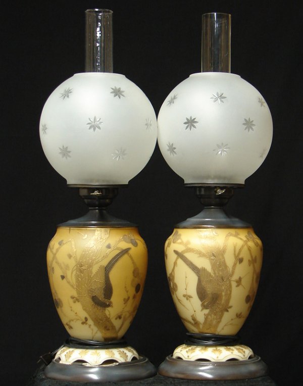 THOMAS WEBB LAMPS MATCHED PAIR: 2 fantastic lamps, made by Thomas Webb and Sons. The lamp base is a satin glass vase shaped barrel with gilded hand painted Japanese style decoration featuring birds. Measures approximately24 inches t