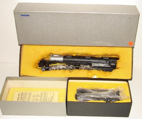 BRASS TENSHODO UP 4-8-8-4 BIG BOY & TENDER: BOXED HO BRASS ENGINE & TENDER, UNION PACIFIC 4-8-8-4 "BIG BOY", TENSHODO, NO.126. BLACK FACTORY PAINT. ROAD NUMBER 4002. ENGINE HAS FOAM STUCK TO THE TOP FROM BEING STORED AWAY OVER THE YEARS. UNFORT