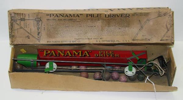 BOXED WOLVERINE PANAMA PILE DRIVER: LOT CONSISTS OF A SCARCE TOY, "PANAMA" PILE DRIVER BY WOLVERINE. APPEARS TO BE COMPLETE WITH MARBLES. TOY SHOWS SOME EDGE AND CORNER WEAR WITH SOME PAINT SCUFFS AND SCRATCHES. MARBLES ARE SCUFFED. BOX