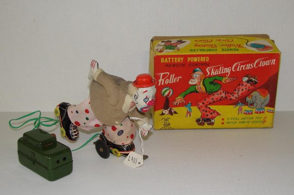 1950's BOXED TPS ROLLER SKATING CIRCUS CLOWN: VINTAGE TIN LITHO BATTERY OPERATED REMOTE CONTROL ROLLER SKATING CIRCUS CLOWN, BY TPS, JAPAN. APPROX. 5-1/2" TALL. REMOTE CONTROL WIRE HAS BEEN CUT FROM THE TOY. NEEDS FIXING. TOY SHOWS SOME EDGE AND