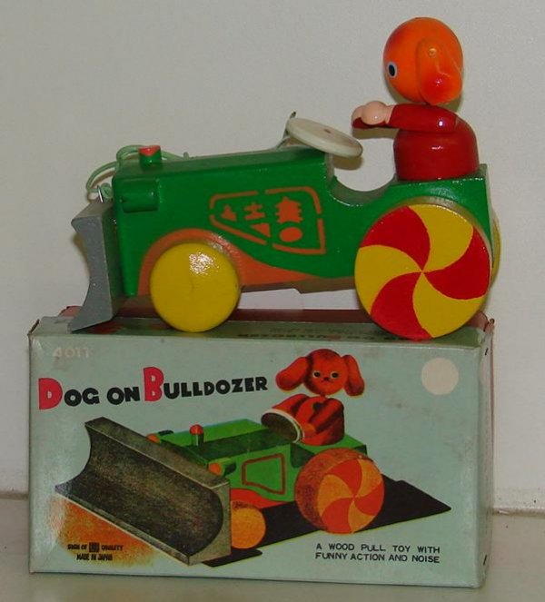 BOXED DOG ON BULLDOZER WOOD PULL TOY JAPAN: LOT CONSISTS OF A BOXED "DOG ON BULLDOZER" WOODEN PULL TOY, MADE IN JAPAN. PIECE IS IN VERY GOOD CONDITION. BOXES SHOWS WEAR WITH CREASES.