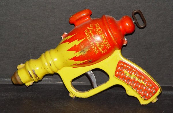 DAISY BUCK ROGERS LIQUID HELIUM WATER PISTOL: ORIGINAL BUCK ROGERS LIQUID HELIUM WATER PISTOL BY DAISY MFG. APPROX. 7-1/2" LONG. PIECE HAS SOME PAINT SCUFFS AND SCRATCHES, BUT OVERALL IN GREAT CONDITION, AND VERY HIGHLY COLLECTIBLE. DON'T THINK T