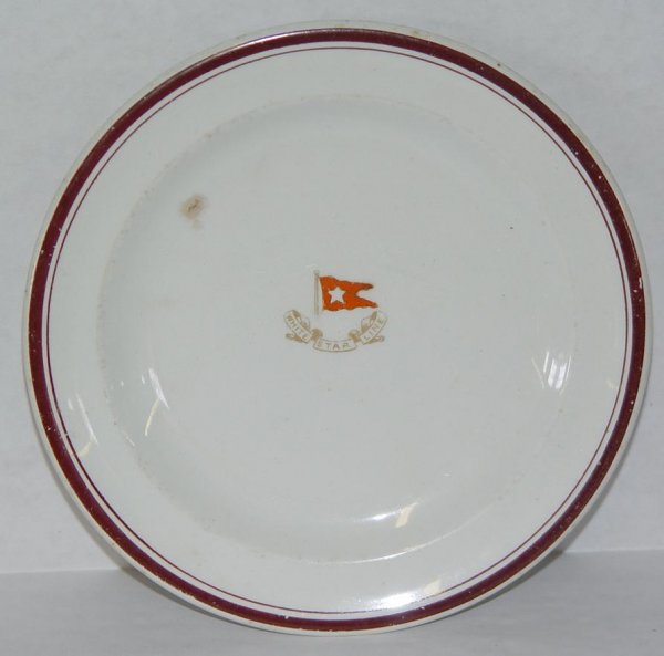 WHITE STAR LINE BRIDGWOOD CHINA PLATE: APPROX. 7-1/4" DIAMETER. WHITE STAR LINE CHINA PLATE. BELIEVED TO HAVE BEEN USED FOR THIRD CLASS SERVICE. SOME SCUFFING THROUGHOUT AND A SMALL BROWN NICK ALONG THE INNER RIM. FROM THE ESTATE OF KEN SC