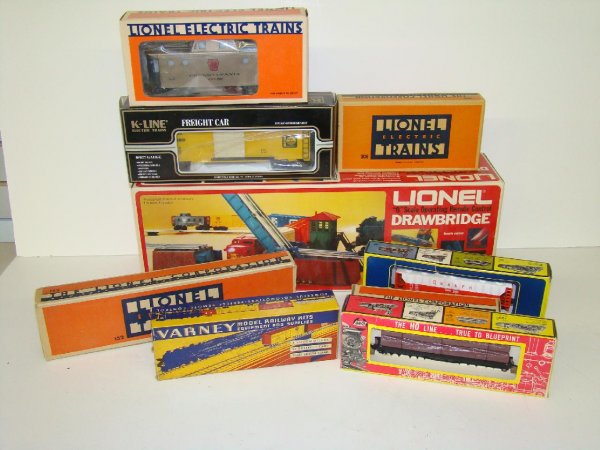 BOX LOT OF ASSORTED TRAINS: LOT INCLUDES LIONEL TRAINS AND DRWBRIDGE, K-LINE TRAINS, VARNEY, AND MARX STEEL GIRDER BRIDGE. EXAMINE.