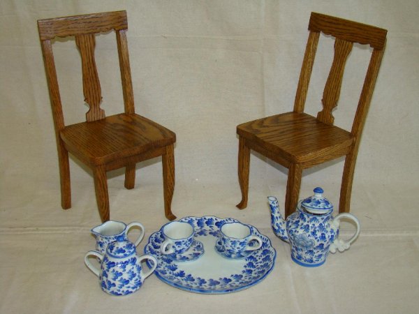 SET OF TWO SOLID OAK T-BACK DOLL CHAIRS.: 14" HIGH & BLUE ON WHITE CHINA TEA SET WITH SILVERWARE TO SET UP A DOLLS TEA PARTY.