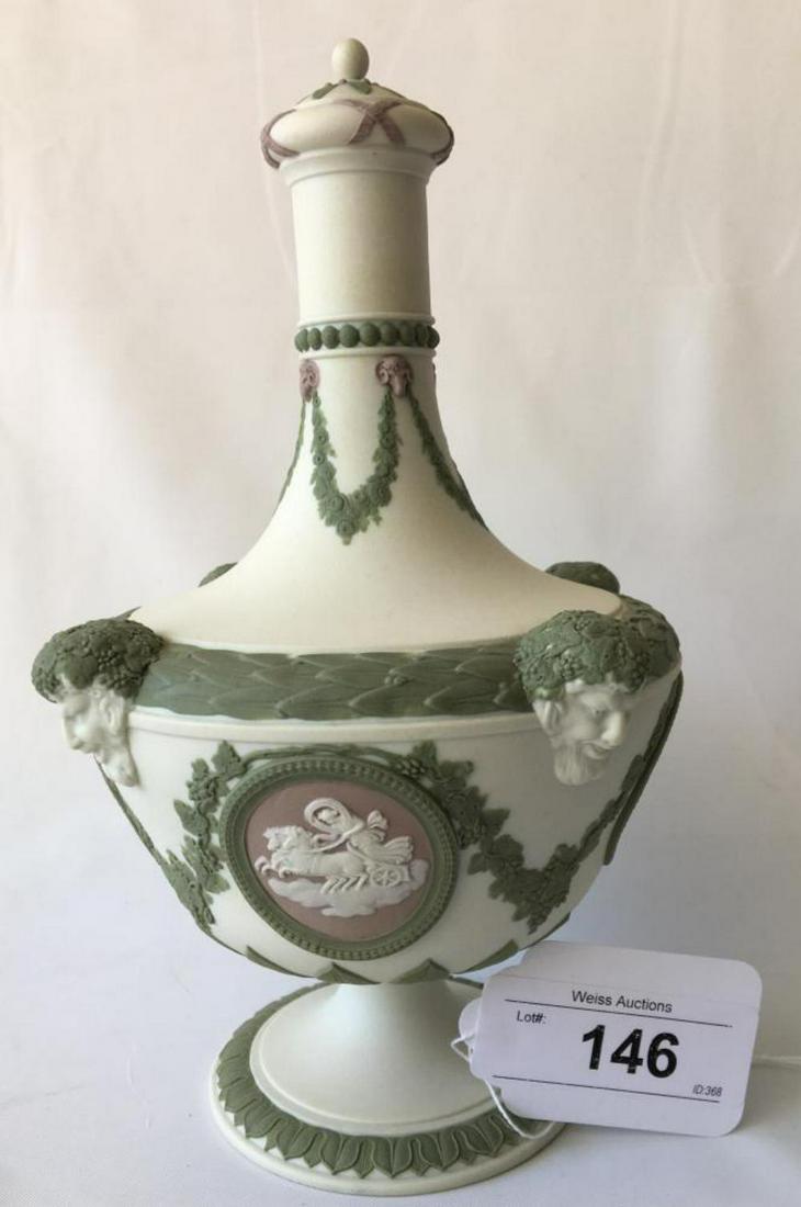 Wedgwood Tricolor Barber Bottle with Lid.: Wedgwood Tricolor Barber Bottle with Lid. Flared bottle form with off white bisque ground, green leaf borders, floral garlands with rams heads, and four heads of Bacchus. Four white framed medallions 