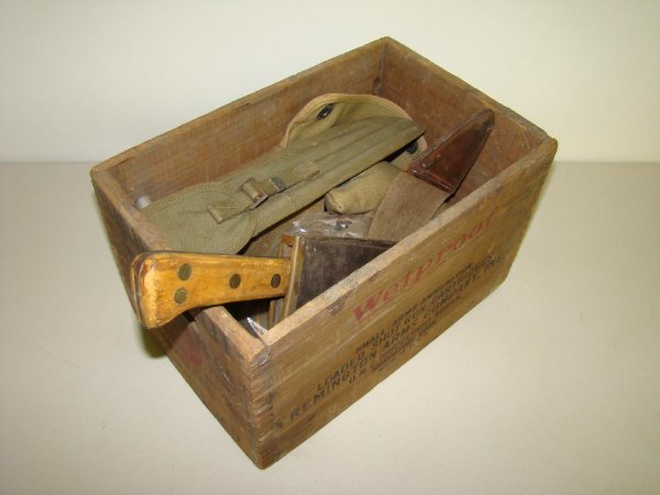 Lot of Military Collectibles: Lot includes; cleaning rod with case, USMC bolo knife and scabbard, field first aid pack, and more. Contents of the lot come in a wooden Shur shot crate. Examine