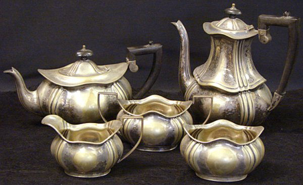 ANTIQUE ART DECO SILVERPLATE TEA SET: Antique Winchester Sheffield Art Deco Silverplate tea set consisting of 5 pieces, a coffee pot and teapot, a creamer, a sugar bowl and a waste bucket. Coffee Pot Measures: 8 3/4" Tall X 4 1/2" WideTea