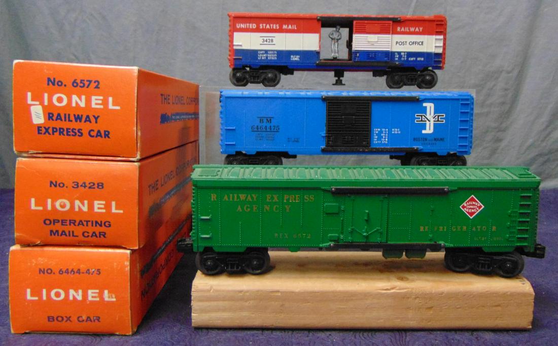 3 Boxed Late Lionel Cars: Includes a 6572 REA Reefer; 6464-475 B&M Boxcar, type IV, both are UNRUN; 3428 Operating Mail car, with bag, while its unrun, it has several rubs on roof with box. From The Estate Collection of Neil P