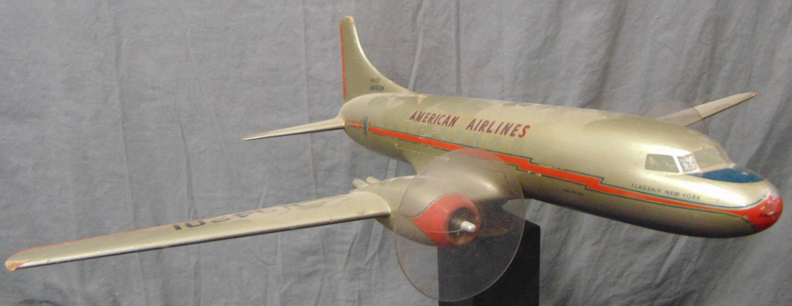 Early American Airlines Convair 240 Agency Model: Probably the 1st PacMin model, circa 1946. Hand carved wooden model, 22” WS with decaled details and nice deco style stand. It has a paint chip on top near tail, and would benefit from a cleaning, b