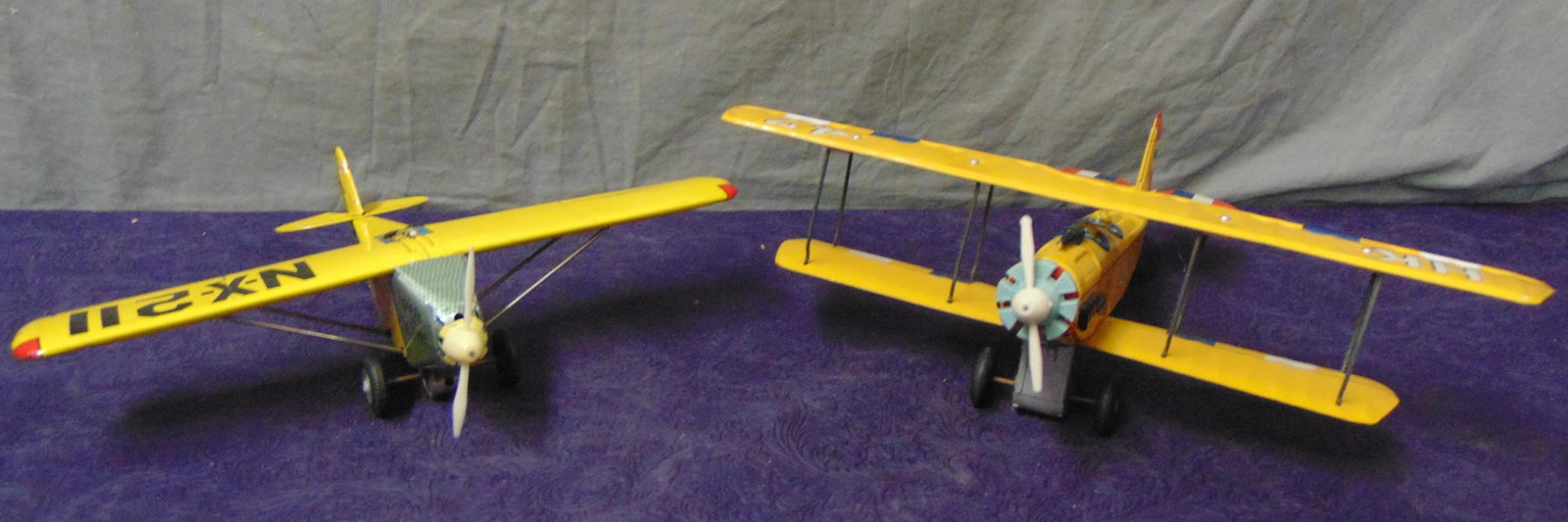 2 Japanese WWI Style Toy Aircraft: Includes a Cragstan litho tin friction bi-plane, 15” WS; HTC Japan, Spirit of St Louis. Both have friction drive with plastic props and shows very light handling.