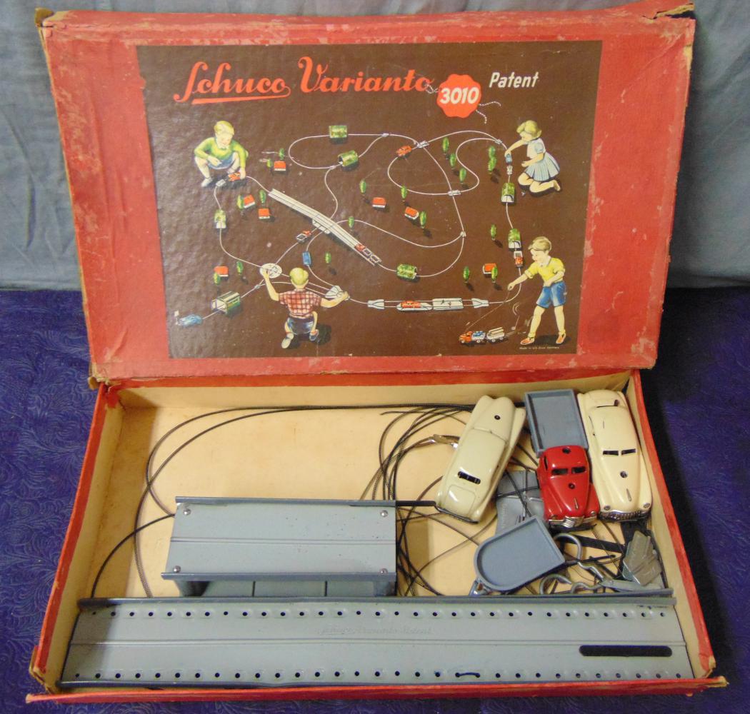 Boxed Schuco 3010 Varianto Set, Plus: Includes a 3042 open truck; 3041 sedan with track and accessories, plus and extra 3041 sedan. All mechanisms functioned at time of test. All show light playwear with worn box.