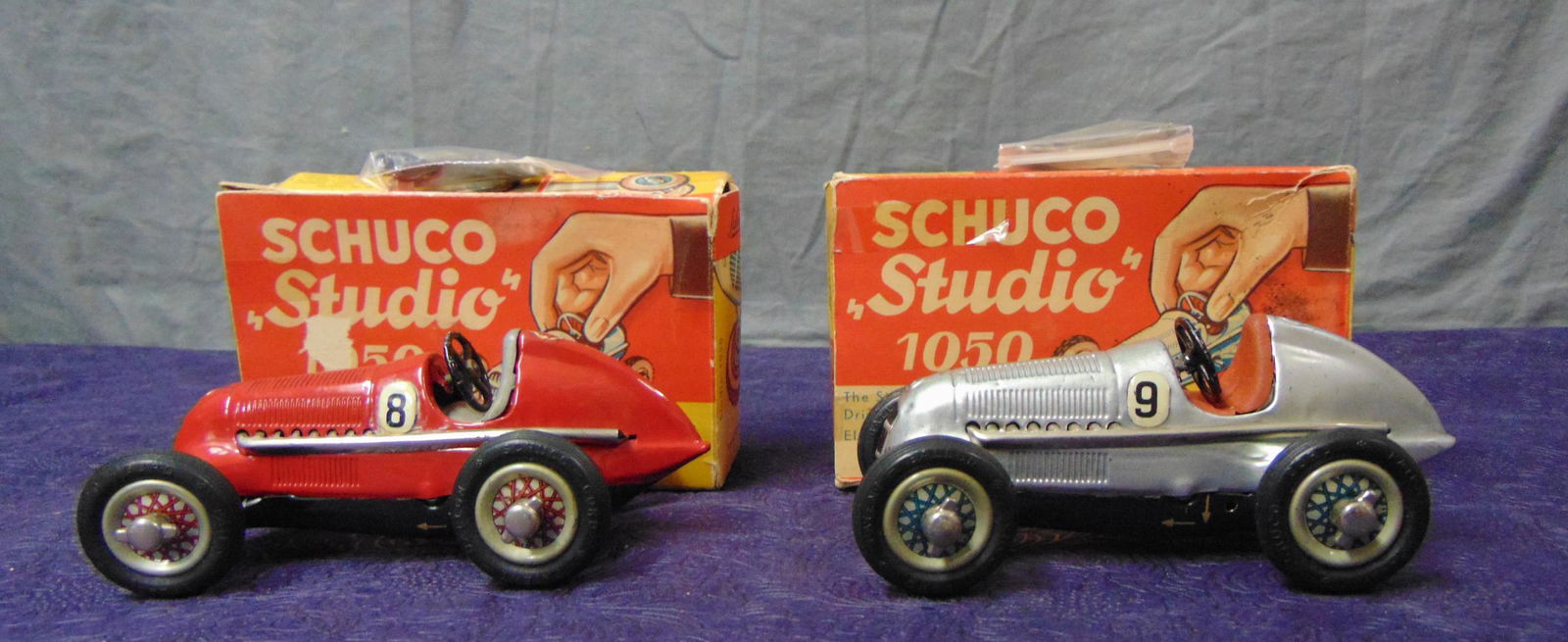 2 Boxed Schuco 1050 Studio Racers: Both are in nice shape with packets. Both mechanisms function and they show light use with lightly worn boxes.