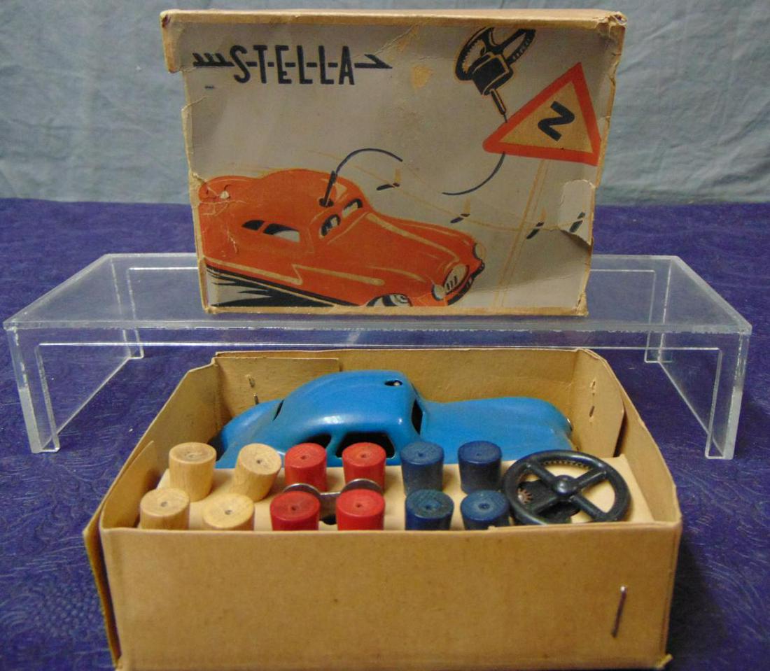 Boxed Stella U-Drive It Car: Germany, nice Schuco knock-off with tin vehicle with functional mechanism, pylons, key and steering wheel with tether wire. It appears lightly played with with lightly worn display box. Unusual!