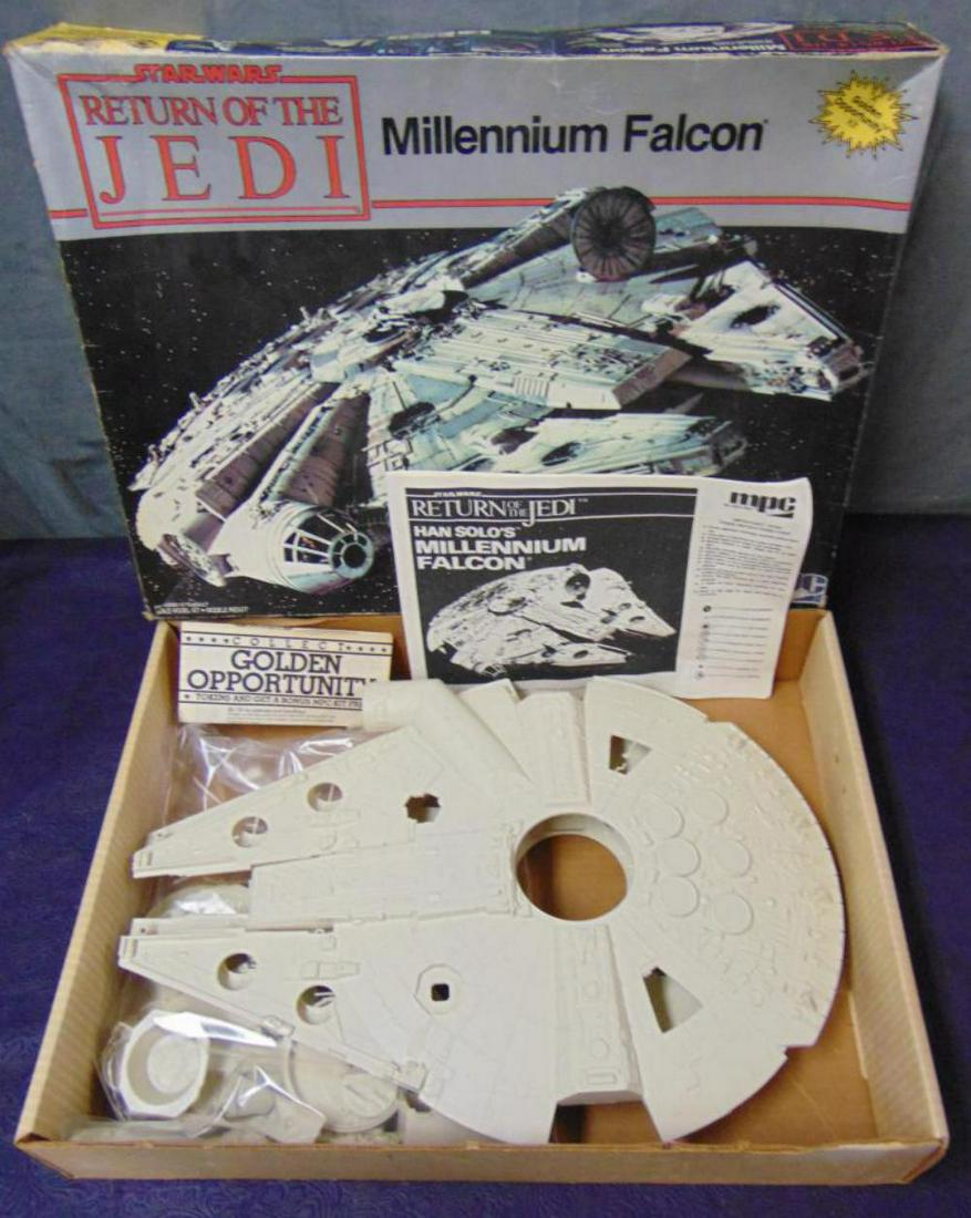 1983 Star Wars Millenium Falcon Model Kit #1933: Vintage and Original, Open Box, Star Wars Return of the Jedi "Millenium Falcon" Model Kit, by MPC, 1983, Kit #1-1933, 1/78 Scale. Box has been opened, and all pieces are loose from the plastic trees.
