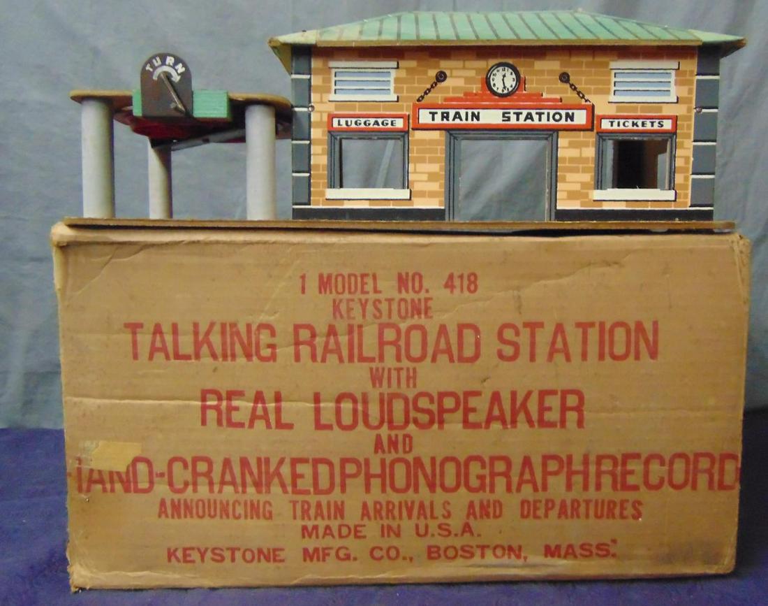 Unusual Boxed Keystone 418 Talking Station: Paper litho over masonite, 17” long. Very colorful and has a crank record player, sort of heard noise when tested. It is fairly clean, showing light use with worn original box. From The Frank Pisani