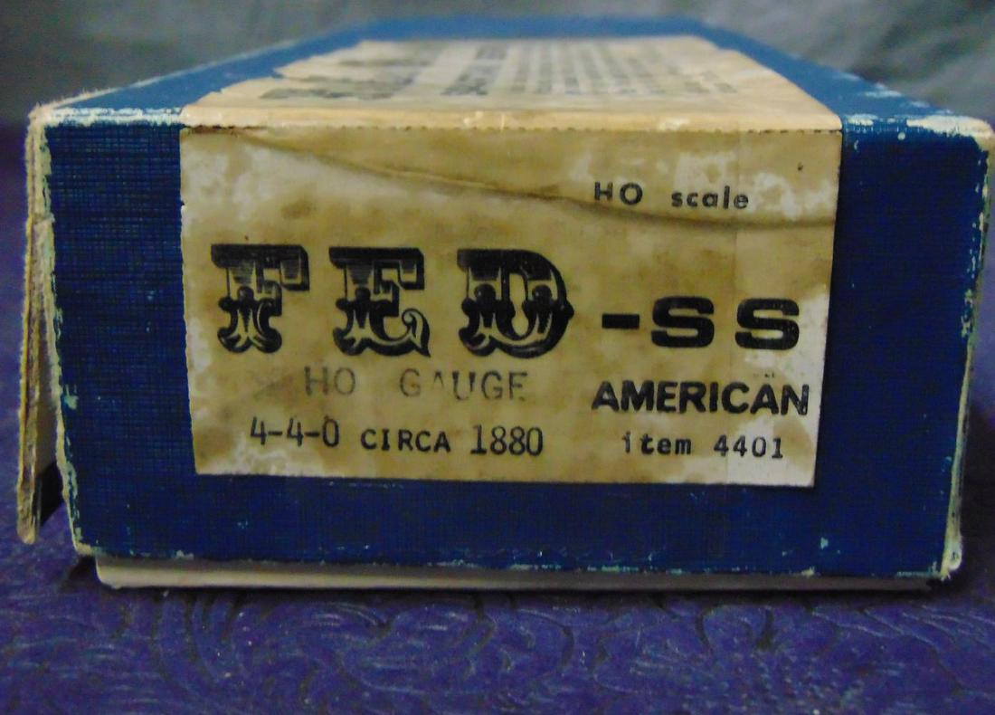 FED HO Brass American & Coach: Nice 4-4-0 American with tender driven open frame motor. It is unpainted brass and appears like new in worn box; plus a Kemtron cast & brass woodside coach, interior seats loose, unfinished with minor