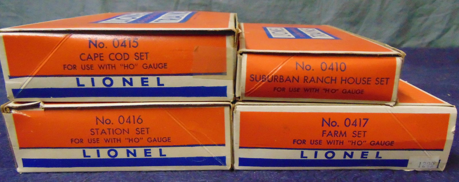 4 Boxed Lionel HO Plasticville Structures: Includes an 0416 Station Set; 0415 Cape Cod Set; 0417 Farm set & 0410 Suburban Ranch House Set. They appear complete, but not collated with lightly worn boxes. From The Estate Collection of Neil Padro