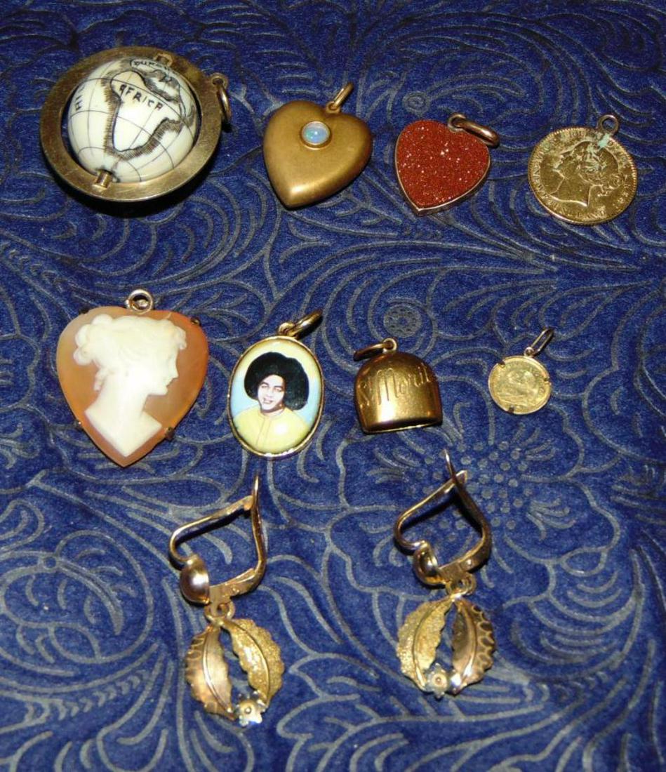 Estate Jewelry Lot.: Lot includes assorted 14 K Pendants, Spinning Globe with Frame 10.4 Grams, Heart Shaped Cameo 3.1 Grams, goldstone Heart 2.0 Gams, Heart Shape Locket Charm with Opal 1.6 Grams,& Oval Portrait of a man