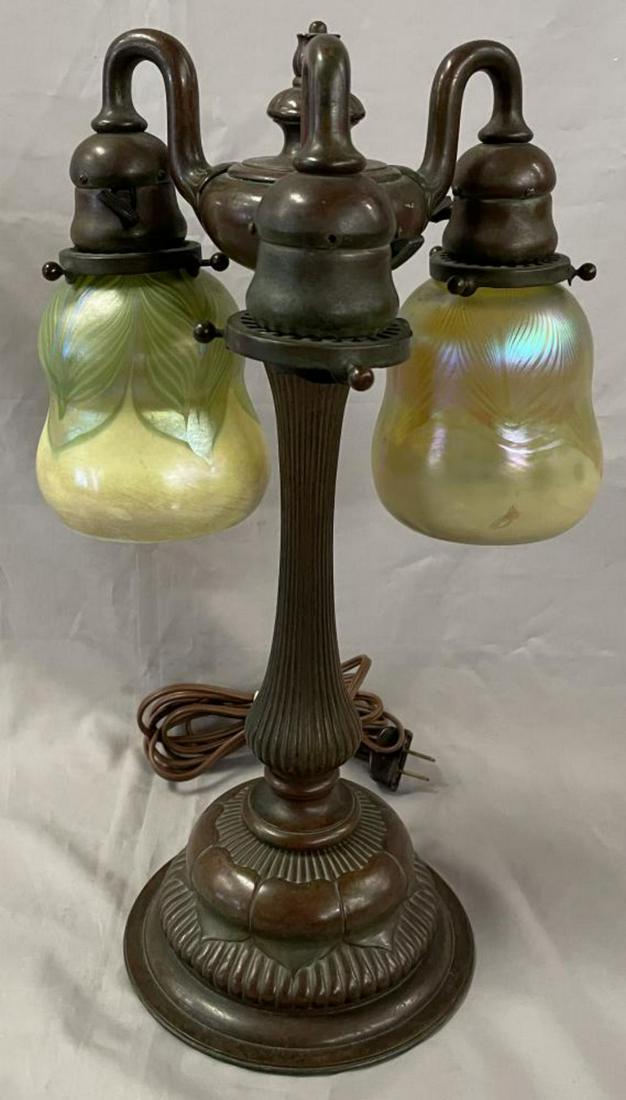 Tiffany Studios Bronze Newell Post Lamp 309: Offered is a Signed Tiffany Studios, New York Bronze 3 Light Newel Post Lamp, #309 with 2 mismatched art glass shades each etched L.C.T. along the top rim. (Missing a shade) Lamp features unusual bron