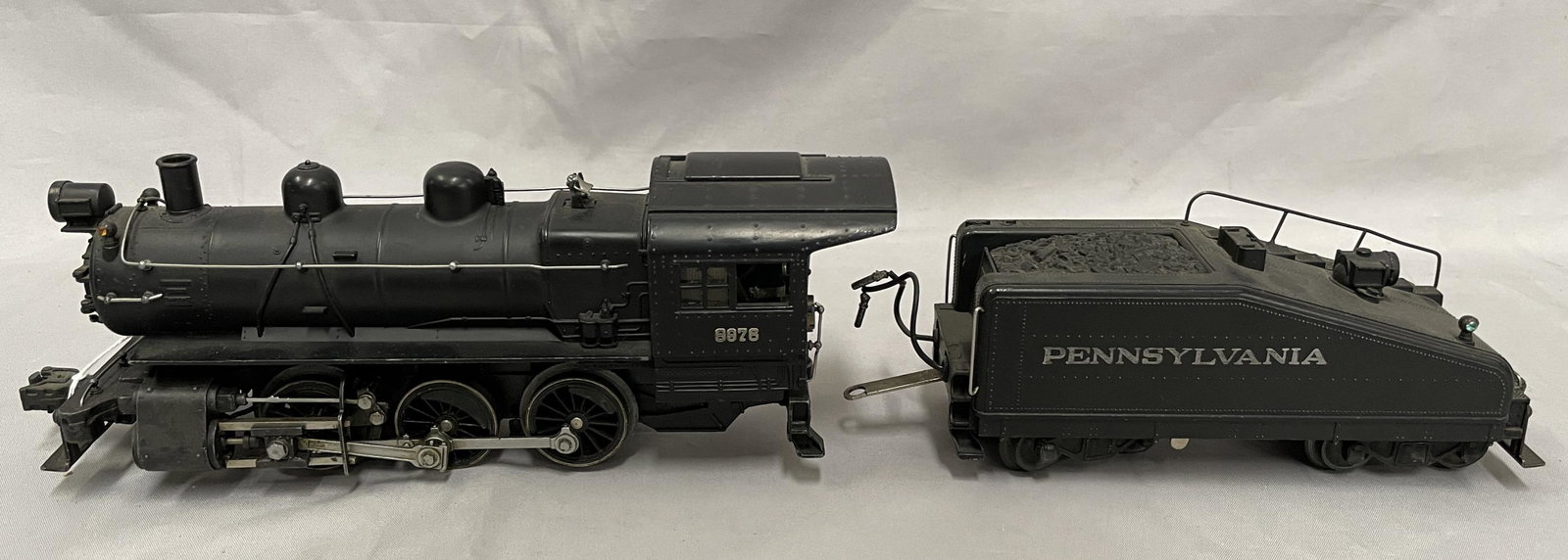 Lionel 227 Semi-Scale B6 Switcher: Clean with nice satin patina, boiler insert painted red, Postwar coupler; 2227B Slant back tender with bell & light, nice lettering with postwar trucks. Shows light playwear.