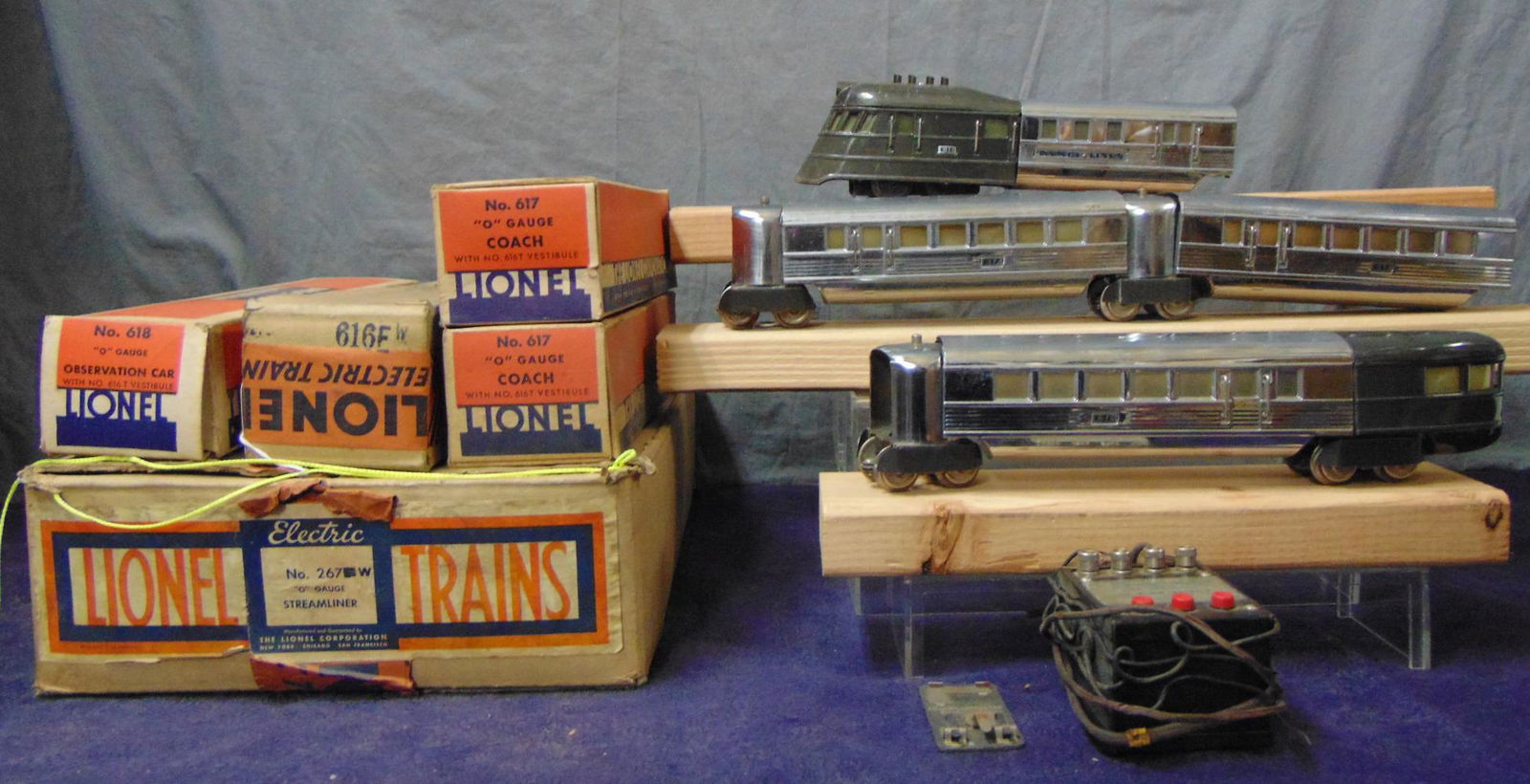 Boxed Lionel 267W Flying Yankee: Fairly clean original owner set, including a 616W diesel; 2 #617 coaches; 618 Observation. All show light playwear with warped boxes, 2 with wrapping, 166, clips box and set box.