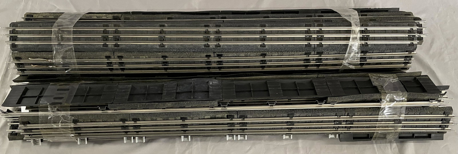 Two Bundles O Gauge Track & Roadbed: Includes about 24 sections of Lionel 3’ tube track straights, with most attached to rubber roadbed. All are fairly clean, showing light use. Large Box required for shipping, so call before bidding f