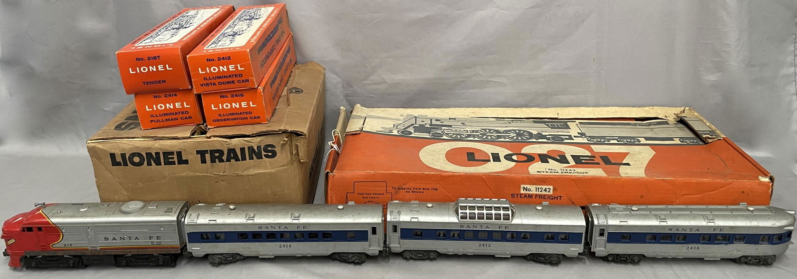 2 Partial Lionel Trains Sets: Includes set 11242 with 233 steam loco; 233W whistle tender; 6476 LV hopper; 6162-110 gondola with canisters; 6465 City Service Tank car, corner chipped; some instructions, some track, billboards & wo