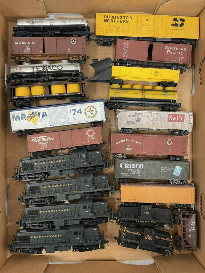 Large Lot HO Diesels and Freight Cars: Includes 4 modern Atlas PRR Diesels, 2 HONG Kong 44-ton diesels, 1 side frame loose with many clean freight cars, most with Kadee couplers.