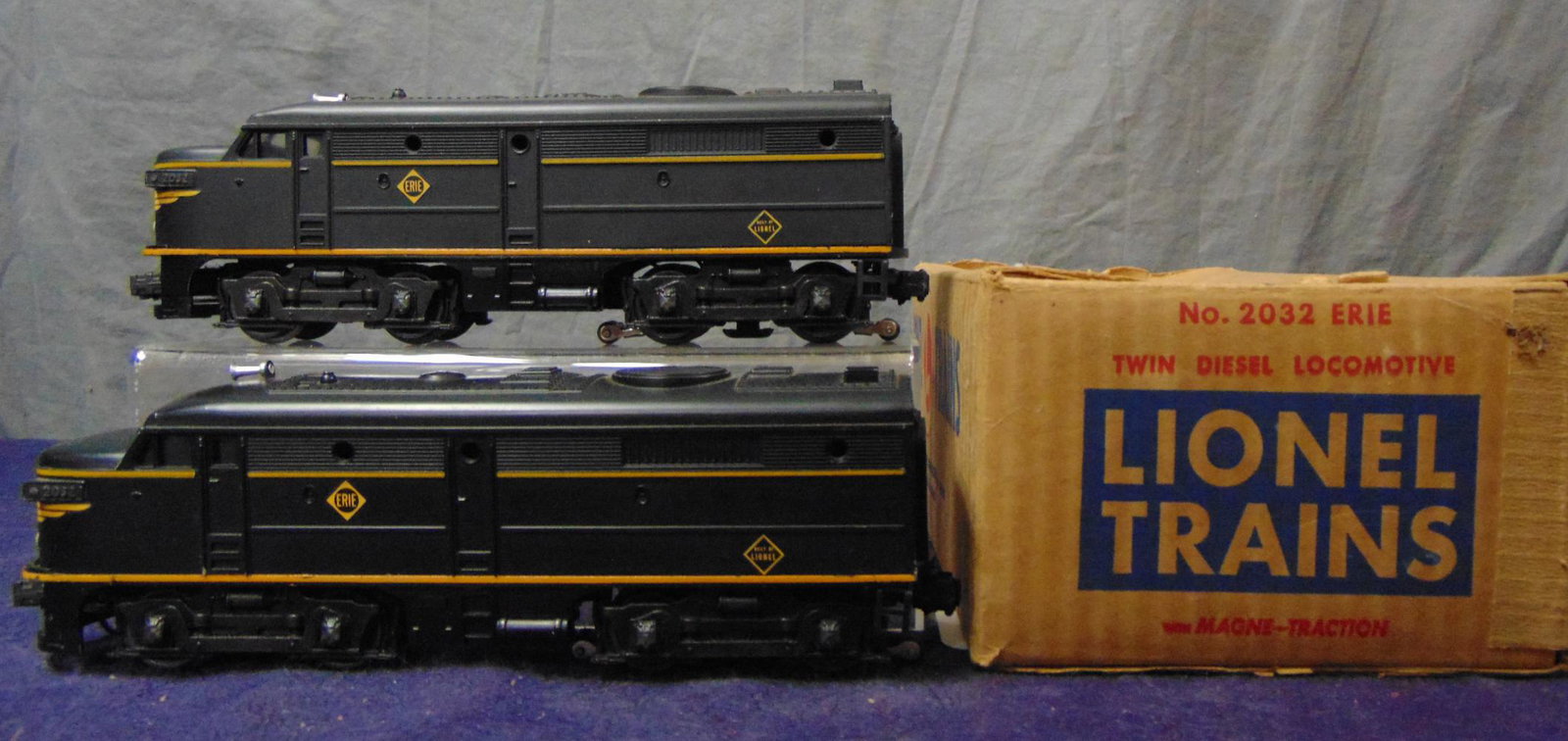 Clean Boxed Lionel 2032 Erie Alco AA Diesels: Beautiful unhandled satin patina. Nose decals are 92%, one flaking, may get worse with shipping, side decals are 100%, battery box is clean and they show light runtime with master carton and 1 small i
