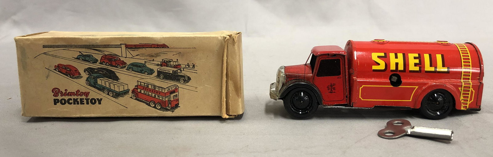 Boxed Brimtoy Pocketoy Petrol Truck: Litho tin wind-up with functional mechanism with key. Light wear to chrome, otherwise like new with nice box.