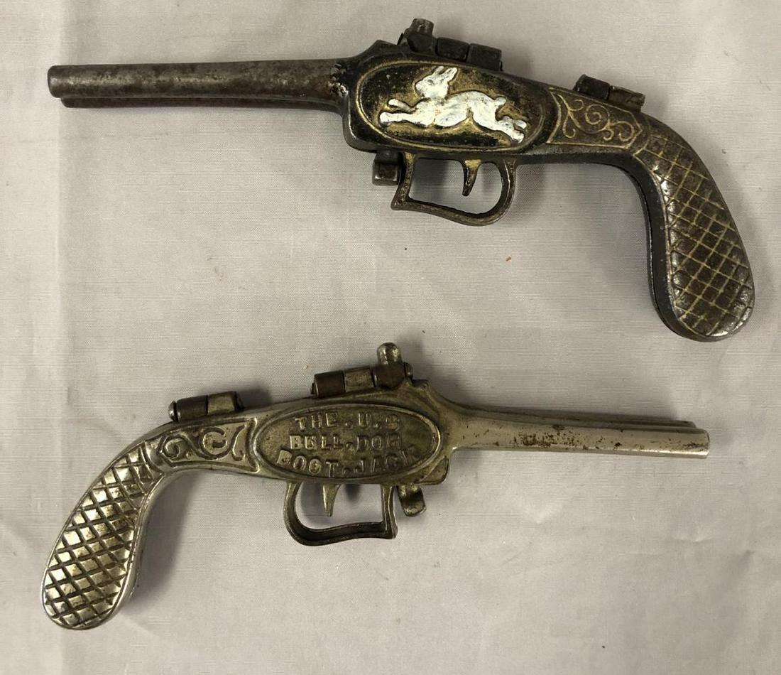 Lot of Two Cast Iron Guns.: Includes The U.S. Bulldog and Boot Jack Rabbit and Dog Folding Pistol. Each 8 1/2" long Nice Paint.