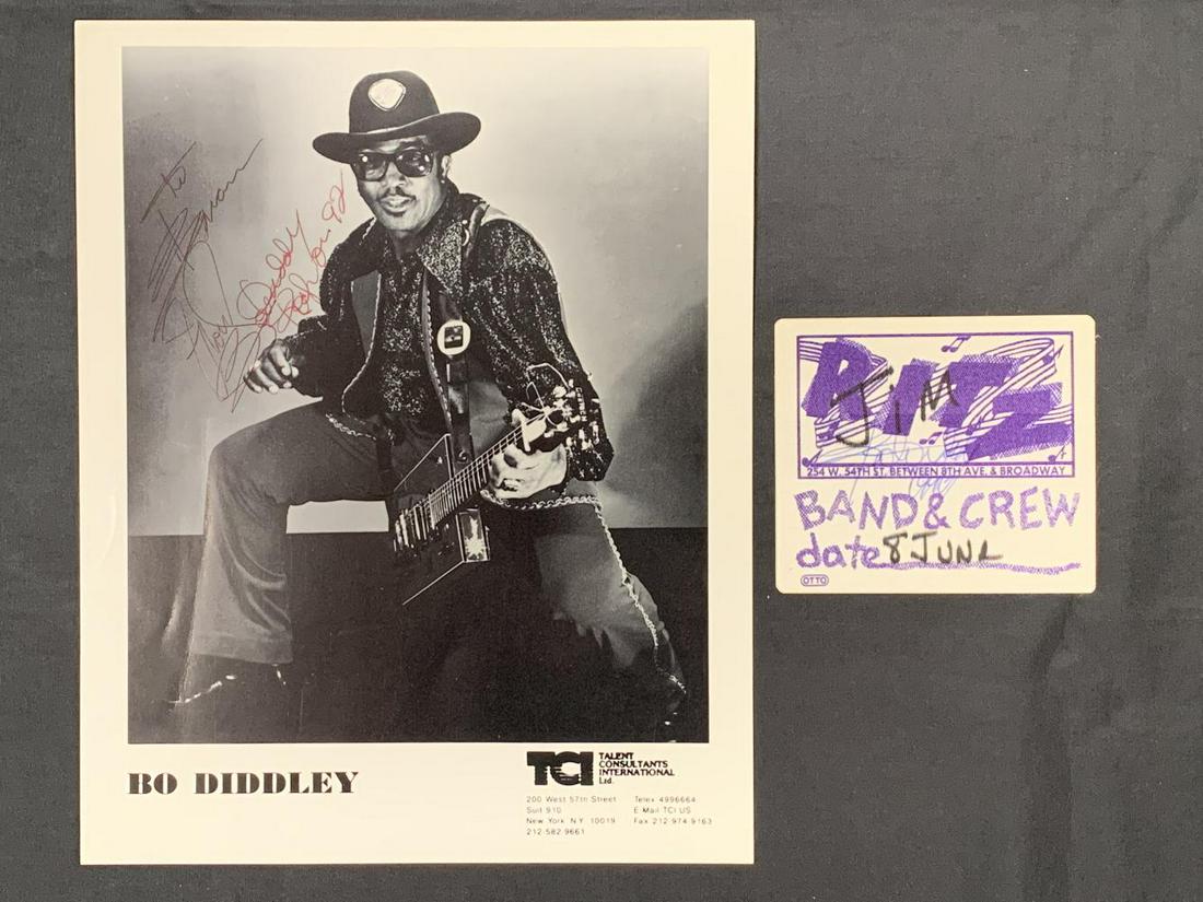 Bo Diddley Signed Photo and Backstage Pass: Bo DIddley Signed Photo and Backstage Pass, both signed in person, 1) 8x10 b&w promo glossy photo, "To Brian, Bo Diddley, 92," + 2) Cloth Backstage Pass, "RITZ," New York CIty, "Band & Crew, June 8," 