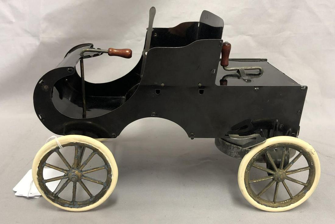 Reproduction Acme Curved Dash Olds: Painted pressed steel with rubber tires, 10” long. Crank spring mechanism functions with velvet set cover. Shows light use. From the Clint Miller Collection.